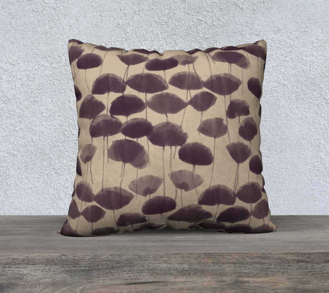 Decorative pillow with brown abstract pattern on a wooden surface and light gray background