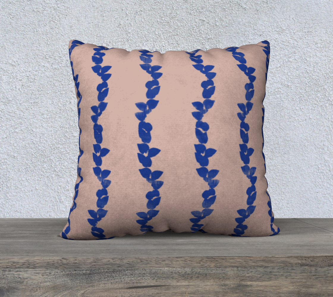 Decorative pillow with blue leaf pattern on a beige background