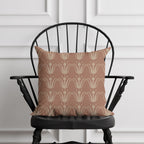 Patterned pillow on a black chair against a white paneled wall