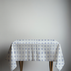 Table with a checkered tablecloth on a plain background
