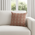 Patterned pillow on a white sofa with a window in the background
