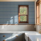 Blue floral watercolor wallpaper in a kitchen with wooden window frame and white tiles.