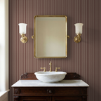 Maroon striped wallpaper in elegant bathroom with brass fixtures and mirror.