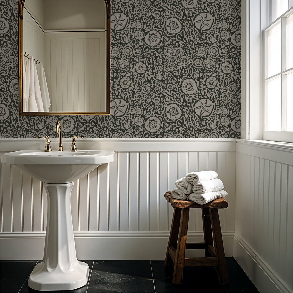 Suzani floral green wallpaper in elegant bathroom with pedestal sink and mirror.